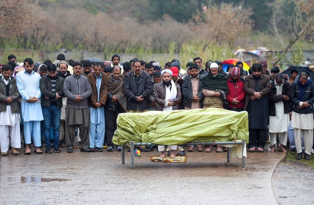Relatives pray for a Pakistani Kashmiri victim who was killed because of the exchange of fire between India and Pakistan near the Line of Control in Pakistan-administered Kashmir, during the funeral, in Islamabad March 11, 2019. u00e2u20acu201d AFP pic